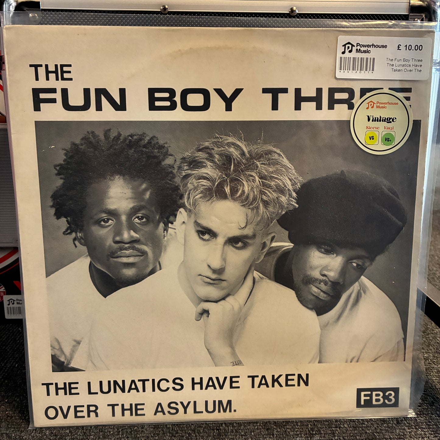 The Fun Boy Three - The Lunatics Have Taken Over The Asylum Vintage Vinyl 12" Single Vinyl record sleeve for The Fun Boy Three's 'The Lunatics Have Taken Over The Asylum' on Powerhouse Records, sealed in a clear plastic case. The cover features a black-and-white portrait of the three band members with bold black text on a cream background, and a Vintage 1970s sticker on the top right.
