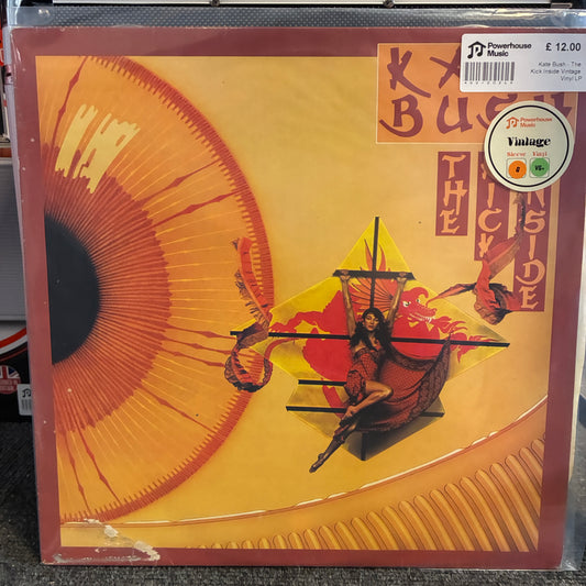 Kate Bush - The Kick Inside Vintage Vinyl LP A vinyl record album cover for 'The Trick Inside' by Kiki Buck, featuring a stylized illustration of a woman in a red dress on a ship with a large golden eye motif on the left. A 'Vintage' record label sticker is visible in the top right corner.