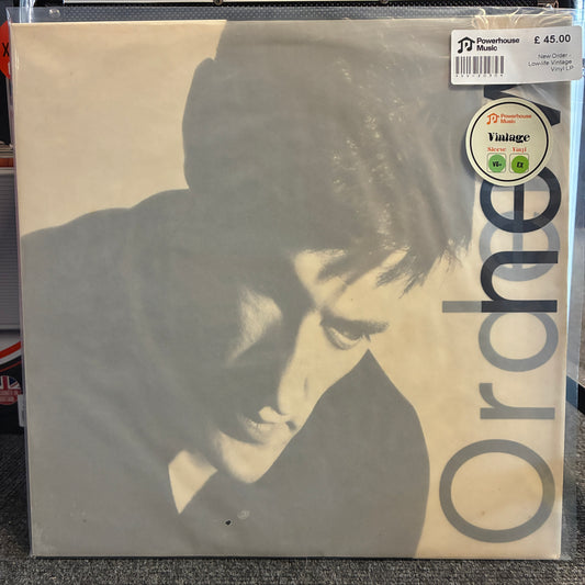 New Order - Low-Life Vintage Vinyl LP A Powerhouse Music 'Vintage' 12-inch vinyl record of the band Ordner's album 'The Longest Way', shown in its original shrink wrap on a gray carpeted floor.