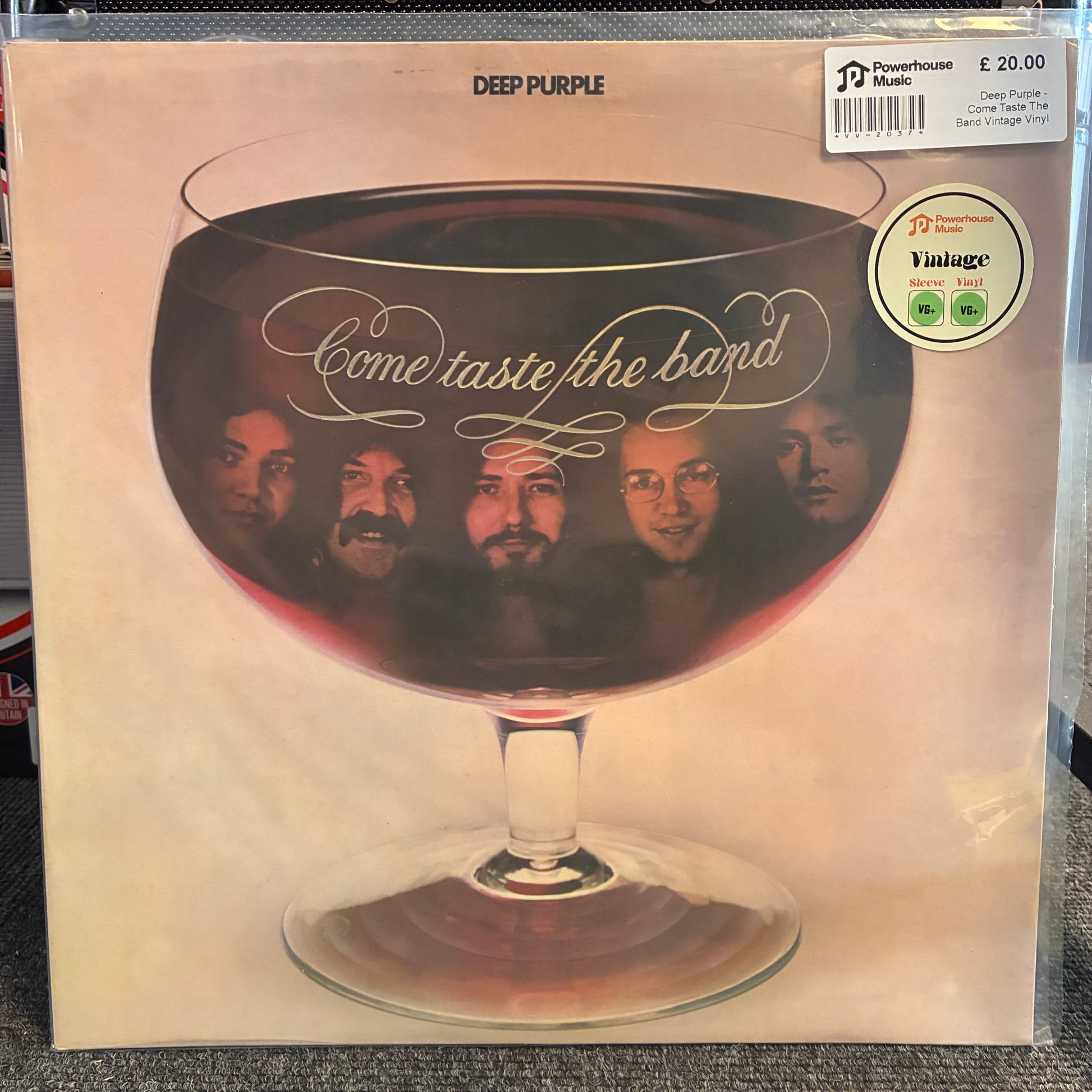 Deep Purple - Come Taste The Band Vintage Vinyl LP Deep Purple 'Come Taste the Band' vinyl record cover, featuring a large glass of red wine with the band members' faces reflected inside. A Powerhouse Music 'Vintage' sticker is visible in the top right corner.