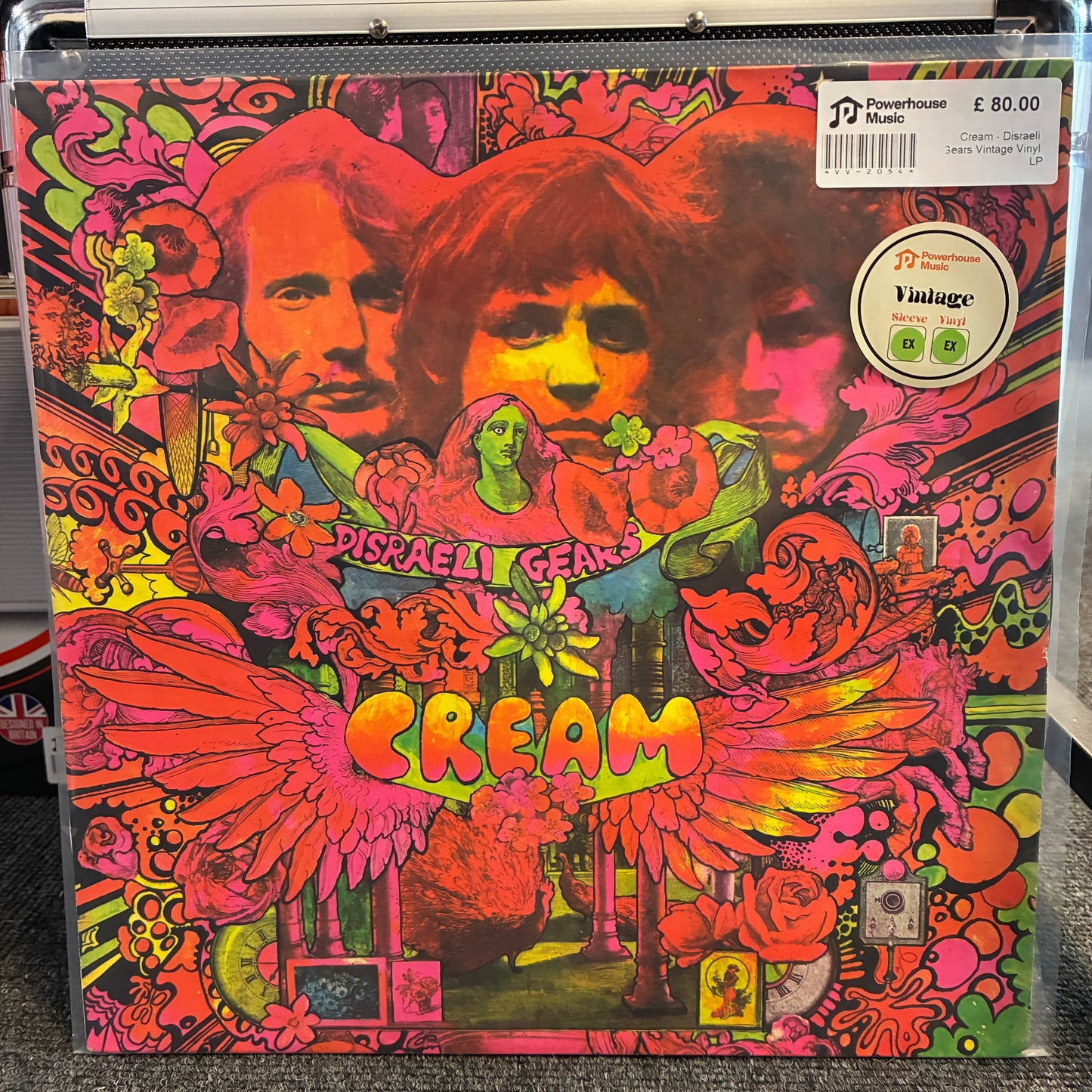 Cream - Disraeli Gears Vintage Vinyl LP Cream's 'Disraeli Gear' vinyl record album cover, featuring a vibrant psychedelic collage with the band members' faces and the title 'CREAM' in large neon letters. The album is photographed inside a clear plastic protective sleeve, with a 'Newhouse Music' barcode sticker and a 'Vintage' price sticker visible on the top right.