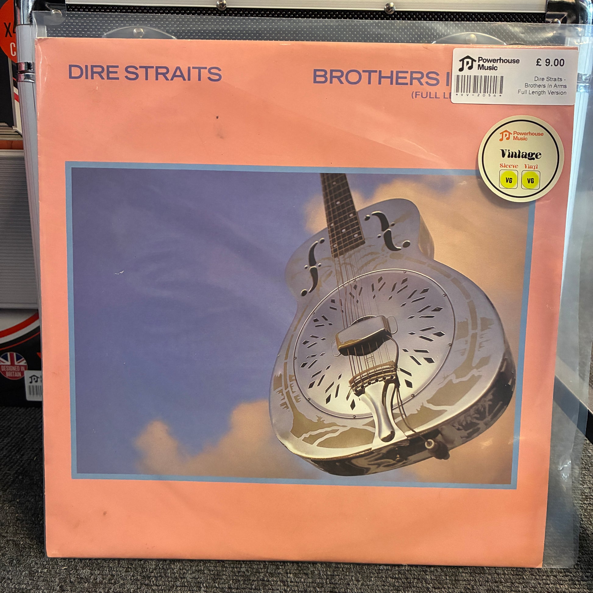 Dire Straits -  Brothers In Arms (Full Length Version) Vintage Vinyl 12" Single Dire Straits 'Brothers in the Family' full-length vinyl record sleeve, sealed in plastic with a Powerhouse Music sticker and a Vintage record sticker on the cover, photographed on a gray carpet.