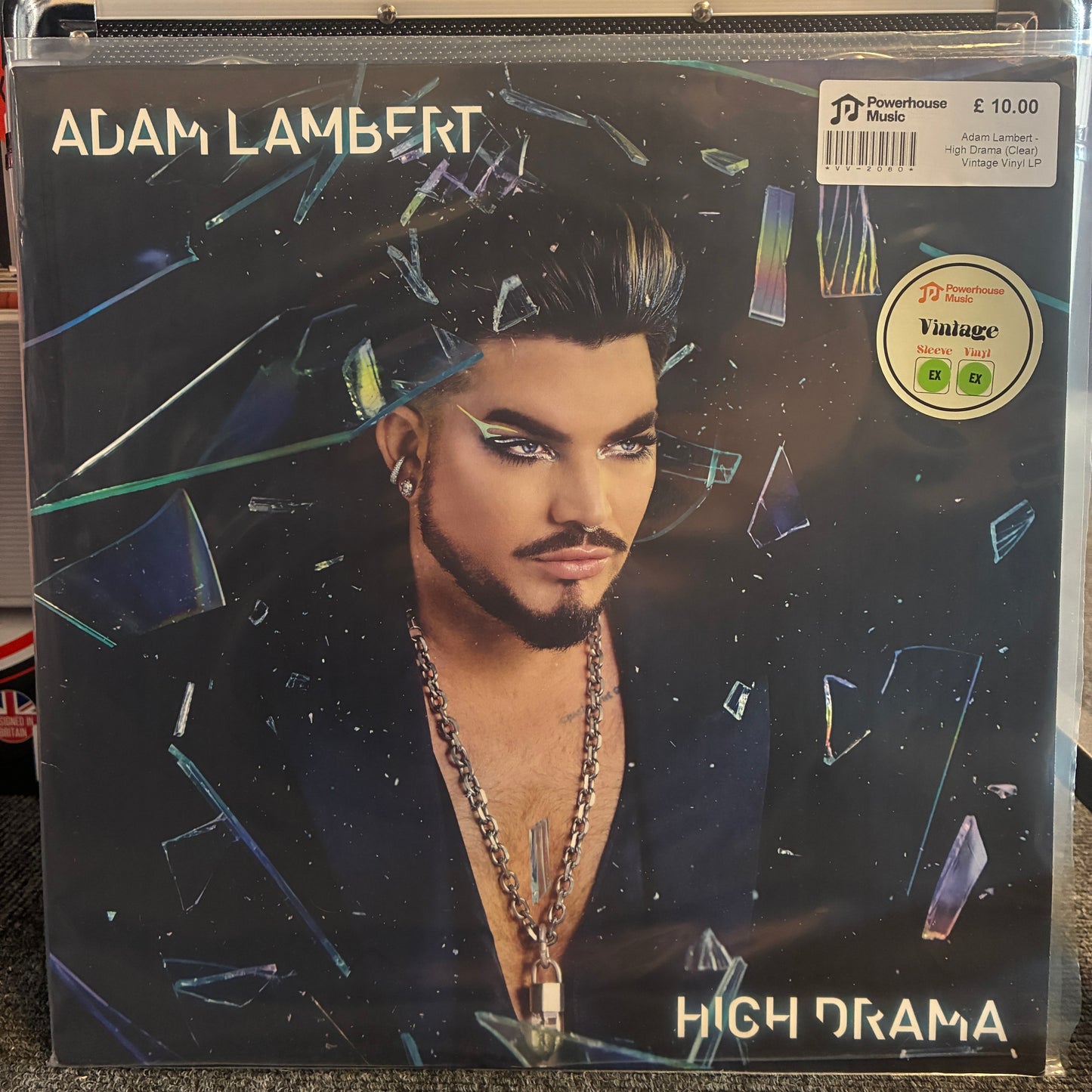 Adam Lambert - High Drama (Clear) Vintage Vinyl LP Adam Lambert 'High Drama' vinyl record album cover, showing a portrait of the artist behind shattered glass with a visible Powerhouse Studio sticker and a Vintage label.