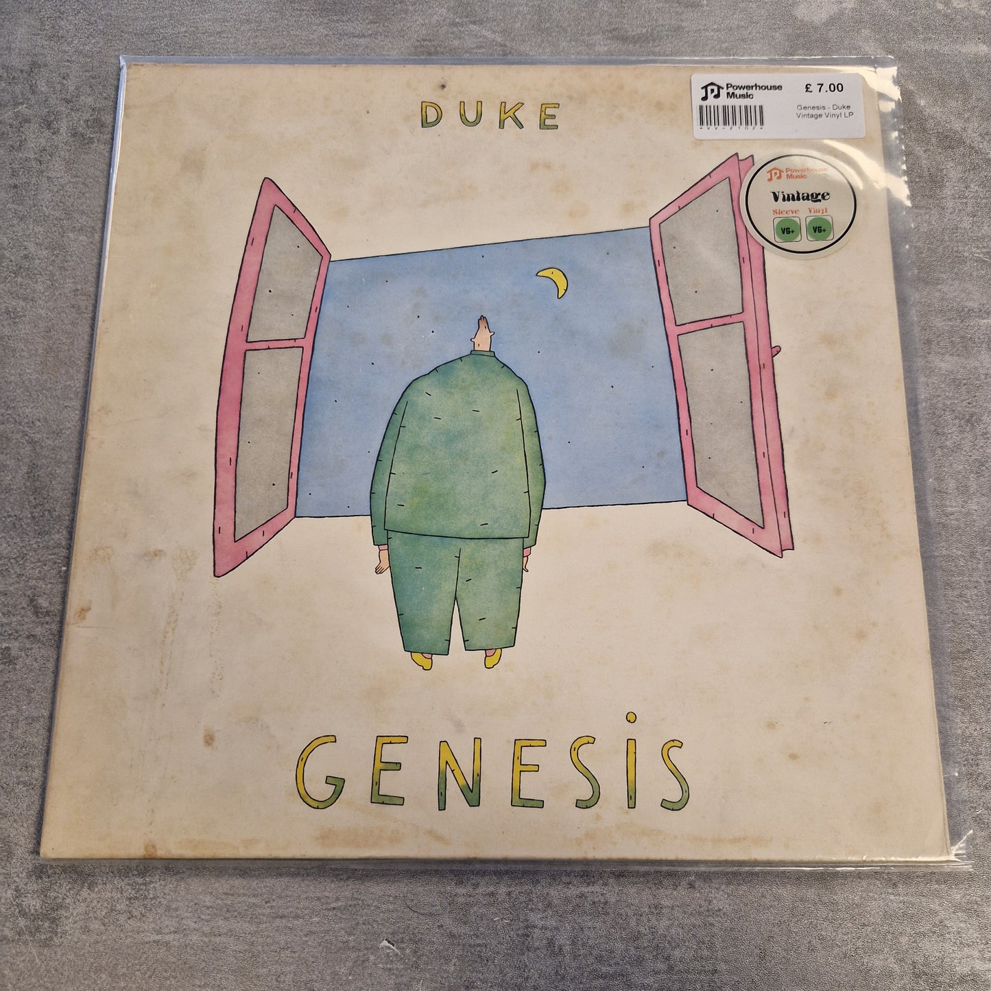 Genesis - Duke Vintage Vinyl LP A square album cover for Duke's 'Genesis' vinyl record, sealed in plastic packaging and placed on a gray textured surface. The cover features a beige background with a whimsical illustration of a green figure standing in front of pink-framed windows under a blue sky.