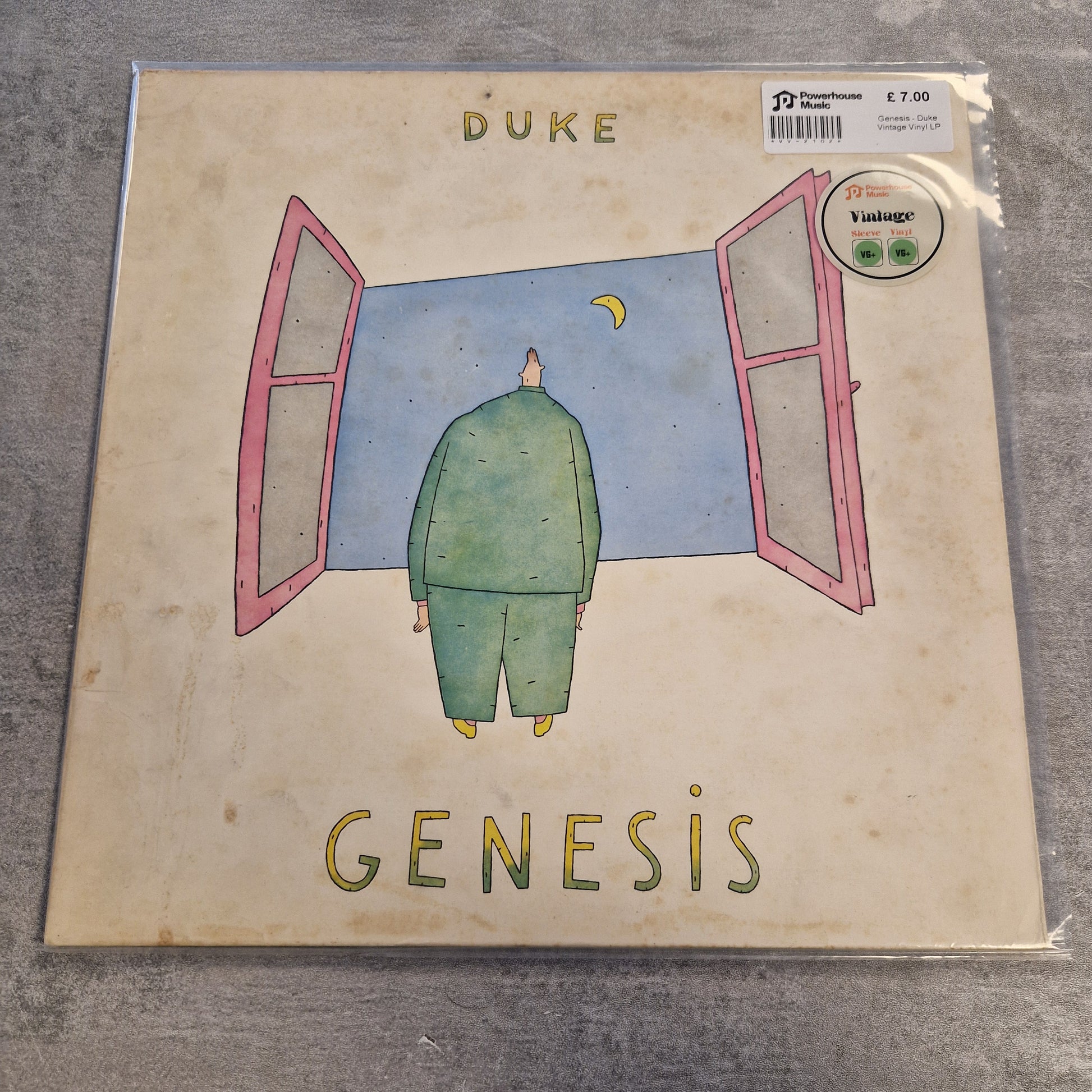 Genesis - Duke Vintage Vinyl LP A square album cover for Duke's 'Genesis' vinyl record, sealed in plastic packaging and placed on a gray textured surface. The cover features a beige background with a whimsical illustration of a green figure standing in front of pink-framed windows under a blue sky.