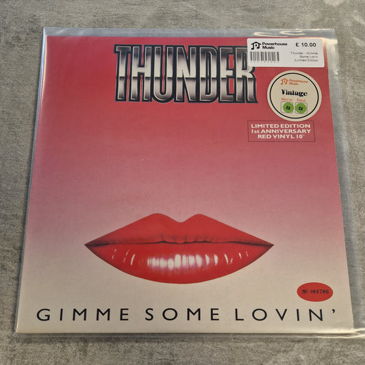 Thunder - Gimme Some Lovin (Limited Edition Red) Vintage Vinyl 10" Single A vinyl record sleeve for the album 'Gimme Some Lovin'' by Thunder, featuring a red lips graphic on a pink-to-white gradient background, photographed in a clear plastic sleeve on a gray textured surface.