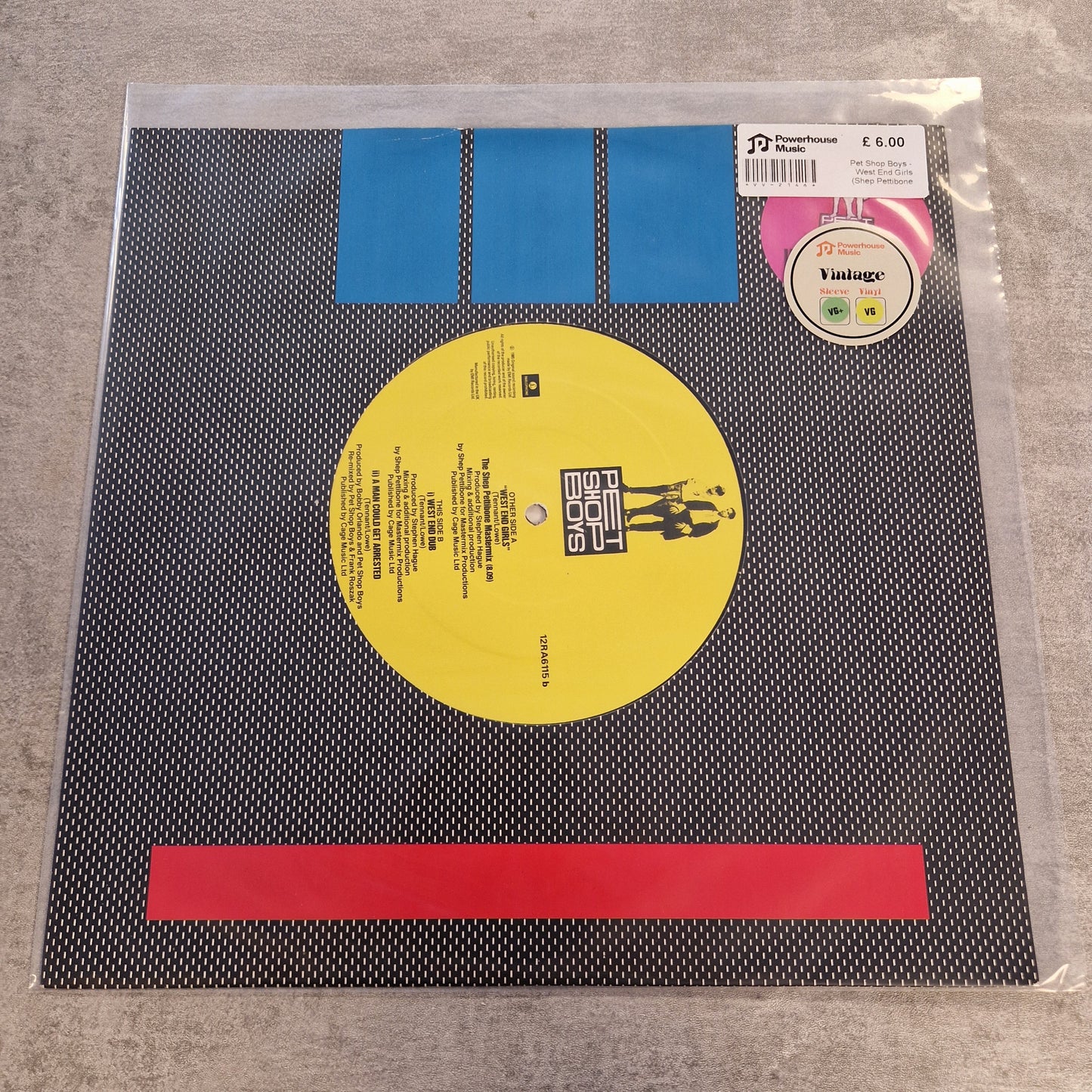 Pet Shop Boys - West End Girls (Shep Pettibone Mastermix) Vintage Vinyl 12" Single A vinyl record sleeve for the album 'Vintagen' by the band 'The Jesus and the Mary Kids', photographed flat on a gray textured surface. The sleeve features a black and white patterned background with blue and red graphic blocks, a yellow center label, and a pink 'Vintage' sticker.