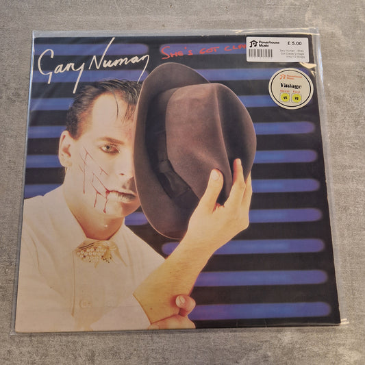 Gary Numan - Shes Got Claws Vintage Vinyl 12" Single A vinyl record sleeve for Gary Numan's 'Smile Again' album, sealed in a clear plastic sleeve, placed on a gray textured surface.