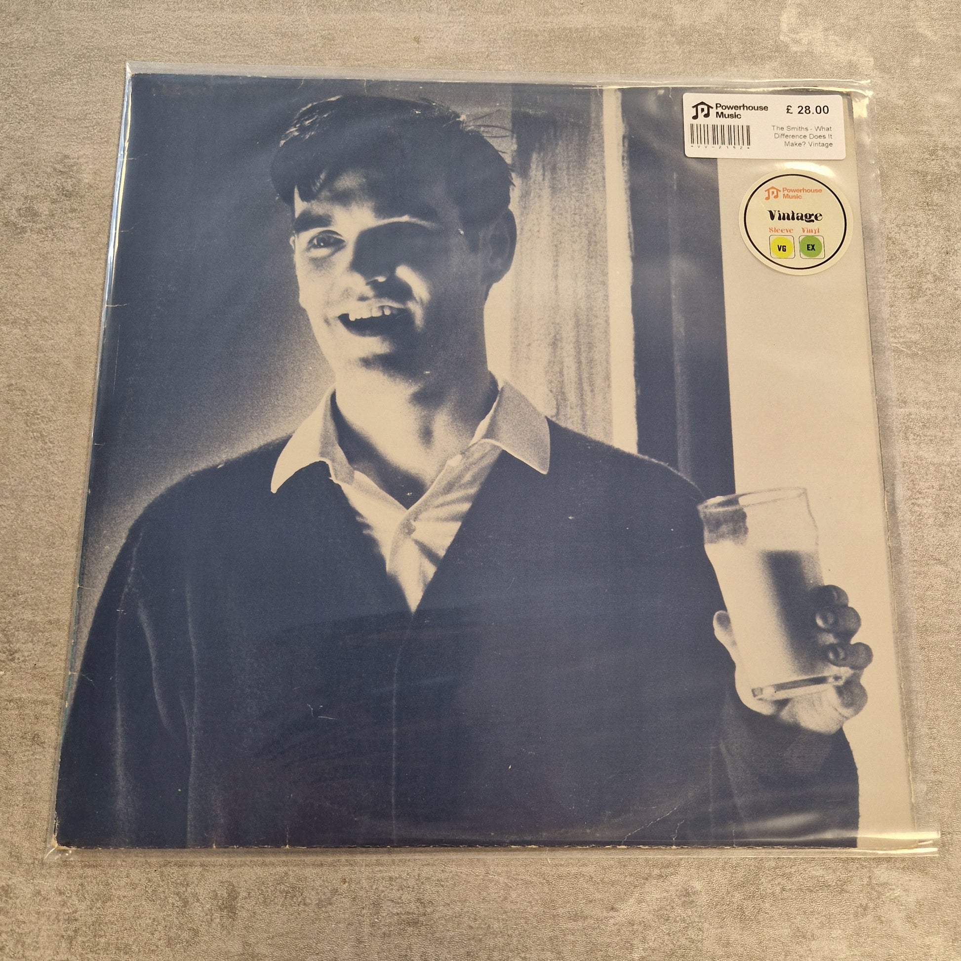 The Smiths - What Difference Does It Make? Vintage Vinyl 12" Single A vintage vinyl record sleeve for Frank Sinatra's 'The Sound of Sinatra' on Columbia Records, sealed in plastic with a barcode sticker and a circular 'Vintage' label, placed on a textured gray surface.