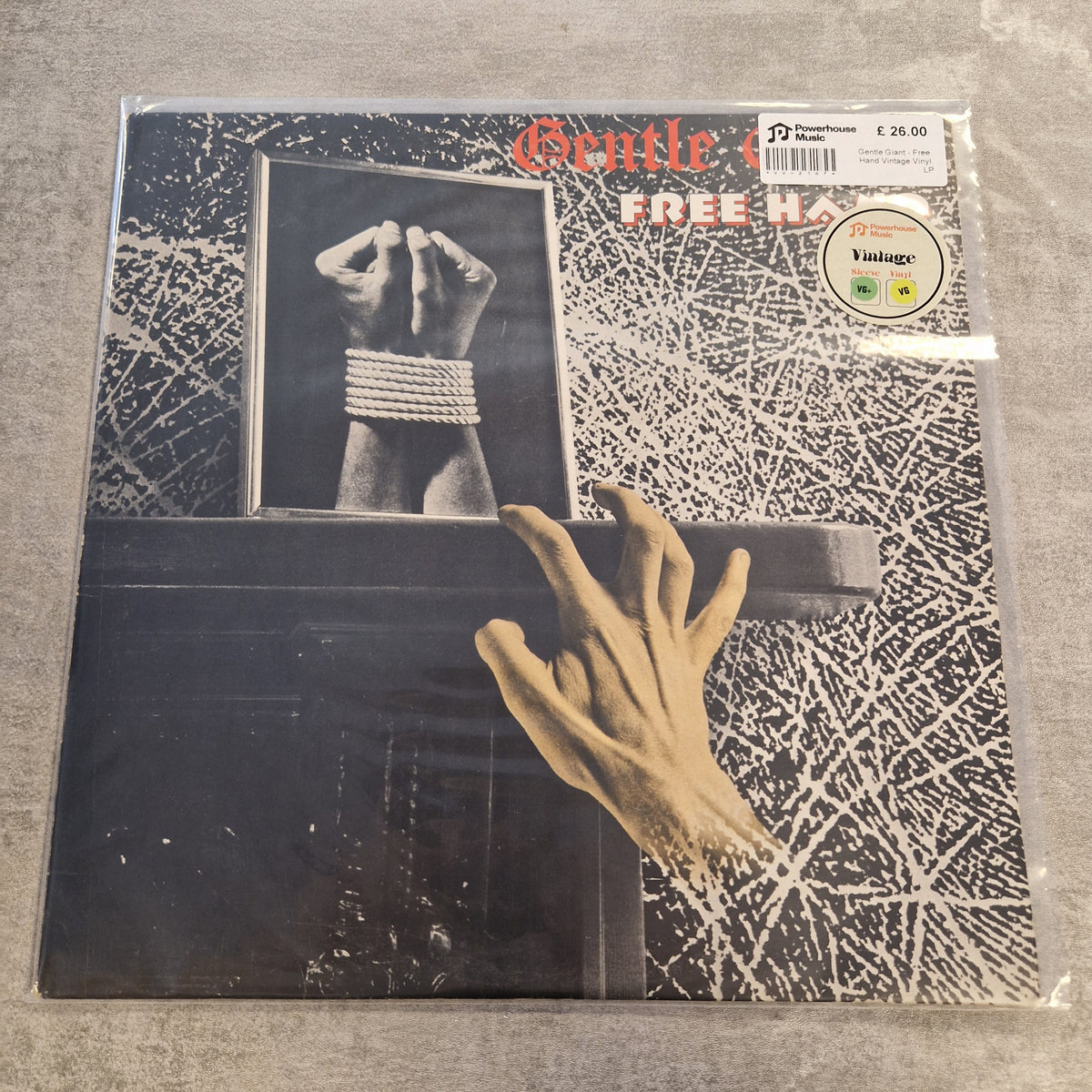 Gentle Giant - Free Hand Vintage Vinyl LP Gentle Monster's 'Free' 12-inch vinyl record LP, sealed in its original plastic shrink wrap. The album cover features a black and white background with a hand reaching out from a dark box, and the title 'Gentle i FREE' in red and white text.