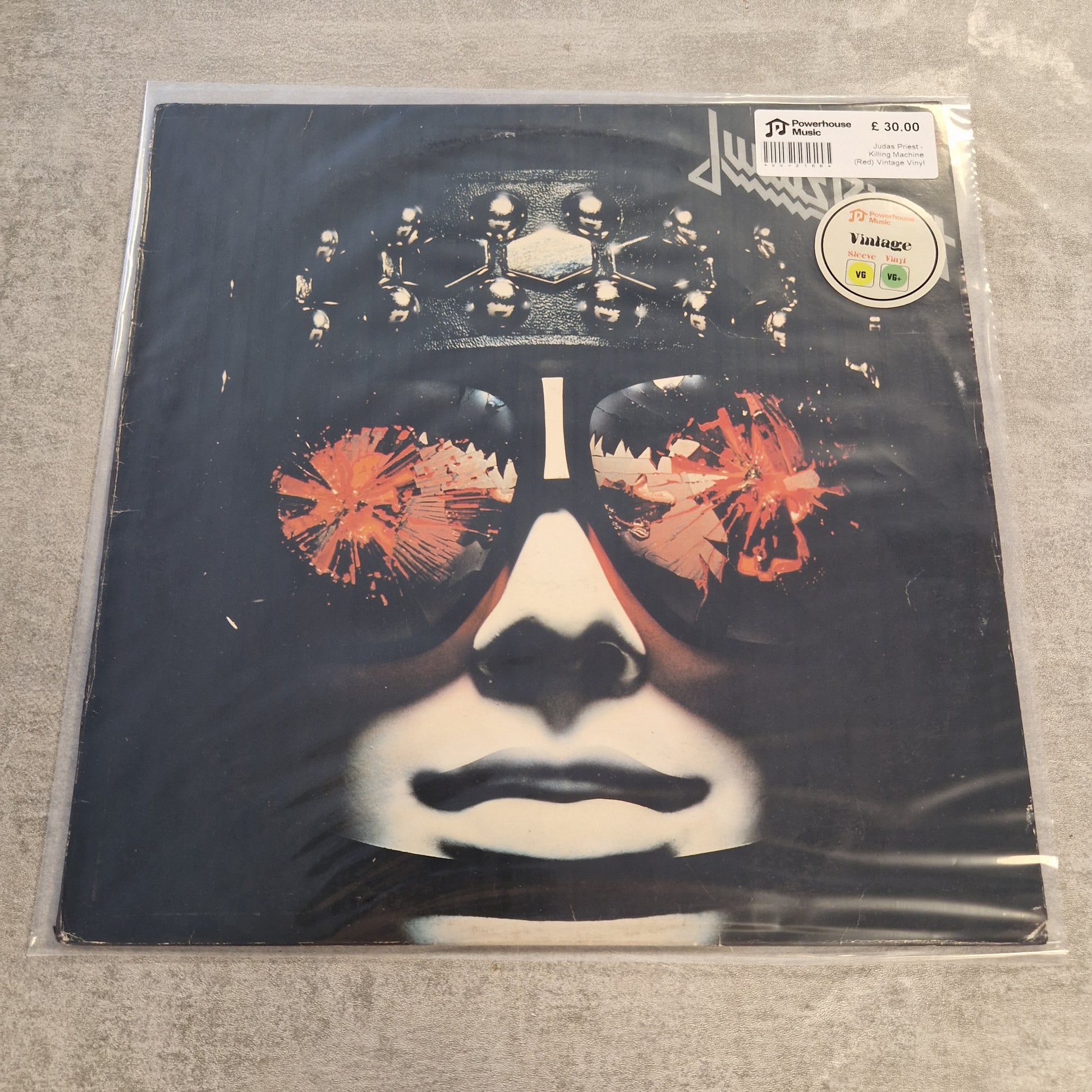 Judas Priest - Killing Machine (Red) Vintage Vinyl LP A vinyl record sleeve for Lou Reed's 'The House of Cards' on Vinted, sealed in a clear plastic protective sleeve. The cover art features a stylized black and white portrait of a face wearing a metallic crown, with orange-red abstract splatters in the eye area.