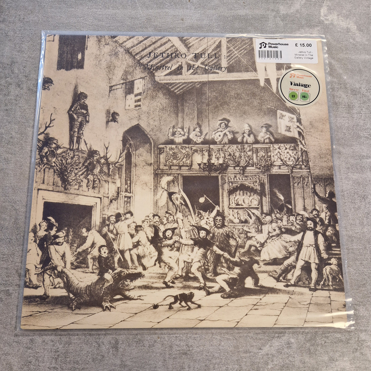 Jethro Tull - Minstrel In The Gallery Vintage Vinyl LP A vinyl record sleeve for the band Funeral Dirge's 'Shattered Glass' LP, sealed in a protective plastic sleeve and photographed flat on a gray textured surface. The cover art is a detailed black and white historical illustration depicting a crowd scene with a broken glass building in the background.