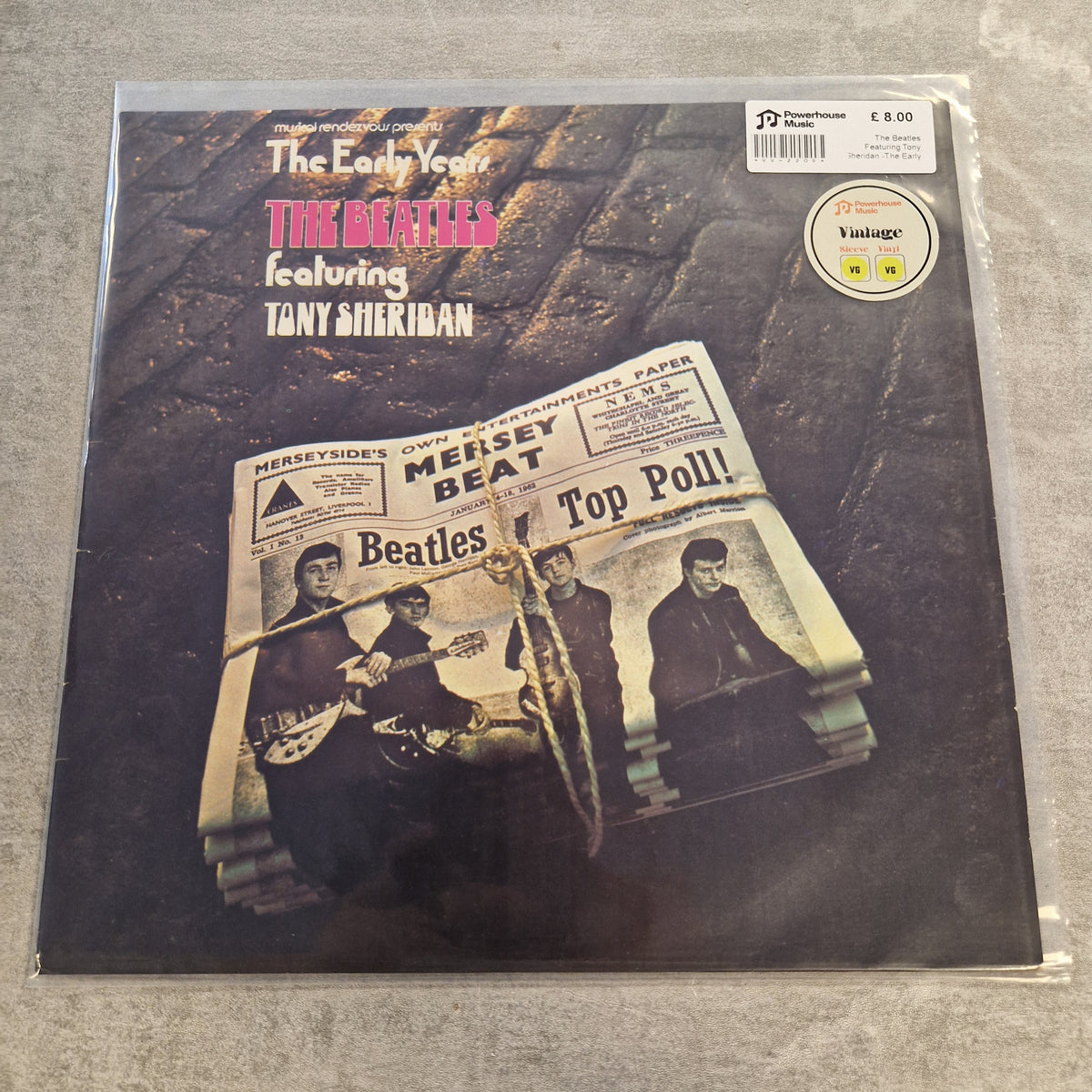The Beatles Featuring Tony Sheridan -The Early Years Vintage Vinyl LP The Beatles 'The Early Years' vinyl record album on a textured gray background, sealed in a protective plastic sleeve with a sticker and barcode label.