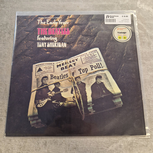 The Beatles Featuring Tony Sheridan -The Early Years Vintage Vinyl LP The Beatles 'The Early Years' vinyl record album on a textured gray background, sealed in a protective plastic sleeve with a sticker and barcode label.
