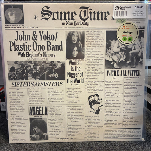 John & Yoko / Plastic Ono Band With Elephants Memory And Invisible Strings - Some Time In New York City Vintage Vinyl LP A vinyl record sleeve featuring a vintage newspaper front page design with music headlines and text, photographed in a clear plastic sleeve on a carpeted floor.