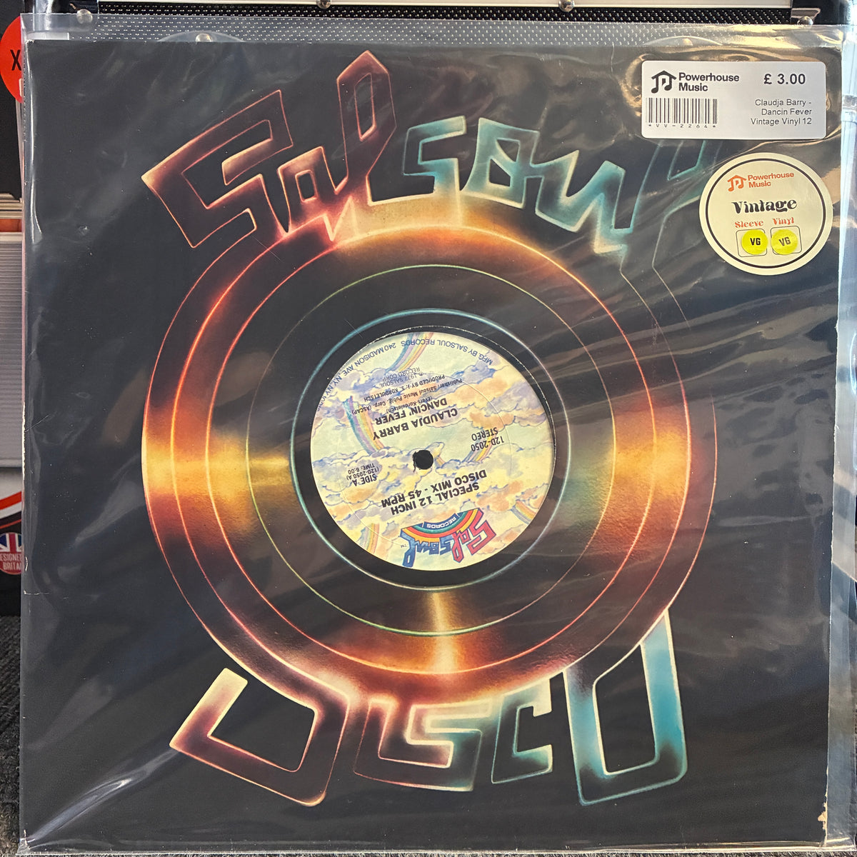 Claudja Barry - Dancin Fever Vintage Vinyl 12" Single A vinyl record sleeve for 'God Save the Disco' by Aerosmith, sealed in a clear protective plastic bag. The sleeve features a black background with a large, stylized neon orange and blue 'God Save the Disco' logo and a detailed record label in the center.