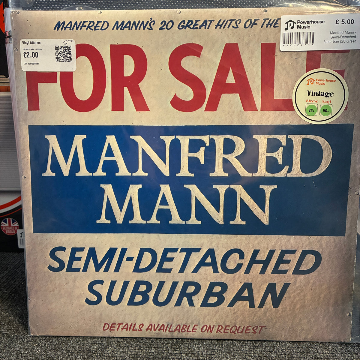 Manfred Mann - Semi-Detached Suburban (20 Great Hits Of The Sixties) Vintage Vinyl LP A vinyl record sleeve for Manfred Mann's 'Semi-Detached Suburban' album, shown in a 'For Sale' condition report style. The cover features a weathered beige background with bold red and blue text, and includes stickers for Powerhouse Music and Vinyne.
