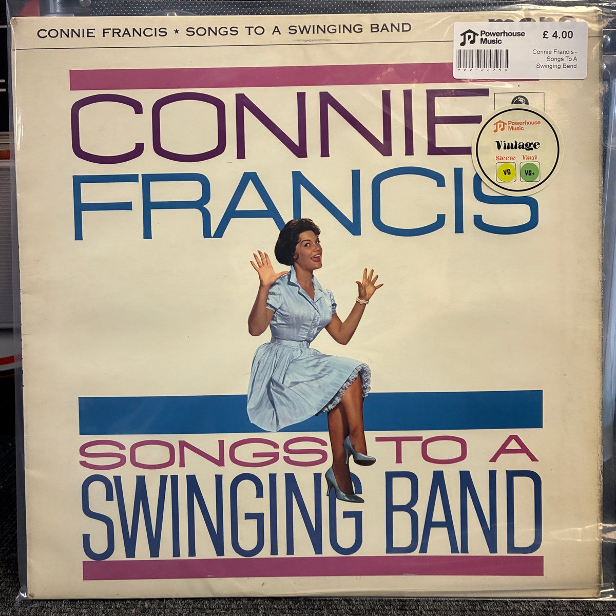 Connie Francis - Songs To A Swinging Band Vintage Vinyl LP Connie Francis 'Songs to a Swinging Band' vinyl record album cover, showing the artist's name in large purple and blue text, an illustration of a woman in a light blue dress, and a Powerhouse Music logo with a Vintage badge.