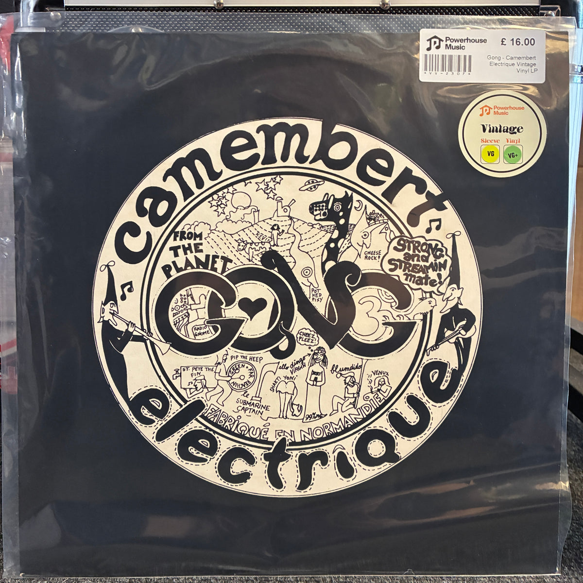 Gong - Camembert Electrique Vintage Vinyl LP A vintage black vinyl record in its original shrink wrap, featuring the band 'Comembersque' and their album 'From the Planet Go!'. The cover has a large white circular graphic with black illustrations and text.