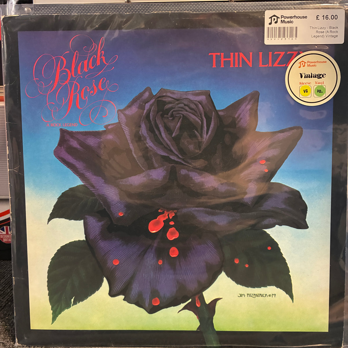 Thin Lizzy - Black Rose (A Rock Legend) Vintage Vinyl LP Vinyl record sleeve for Thin Lizzie's 'Black Rose' album, featuring a large dark purple-black rose with red droplets on a blue-to-green gradient background. Powerhouse Music branding and a Vintage Vinyl sticker are visible on the sleeve.