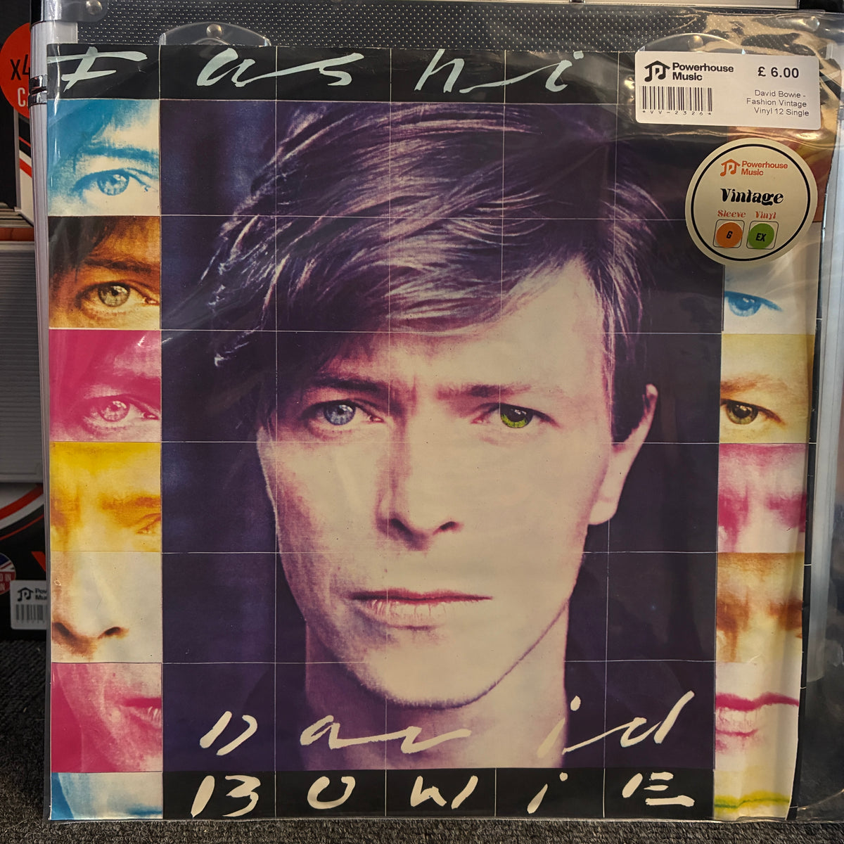 David Bowie - Fashion Vintage Vinyl 12" Single David Bowie 'Fashion' vinyl record album cover, sealed in a clear plastic sleeve with a visible Discman logo and barcode sticker in the top right.