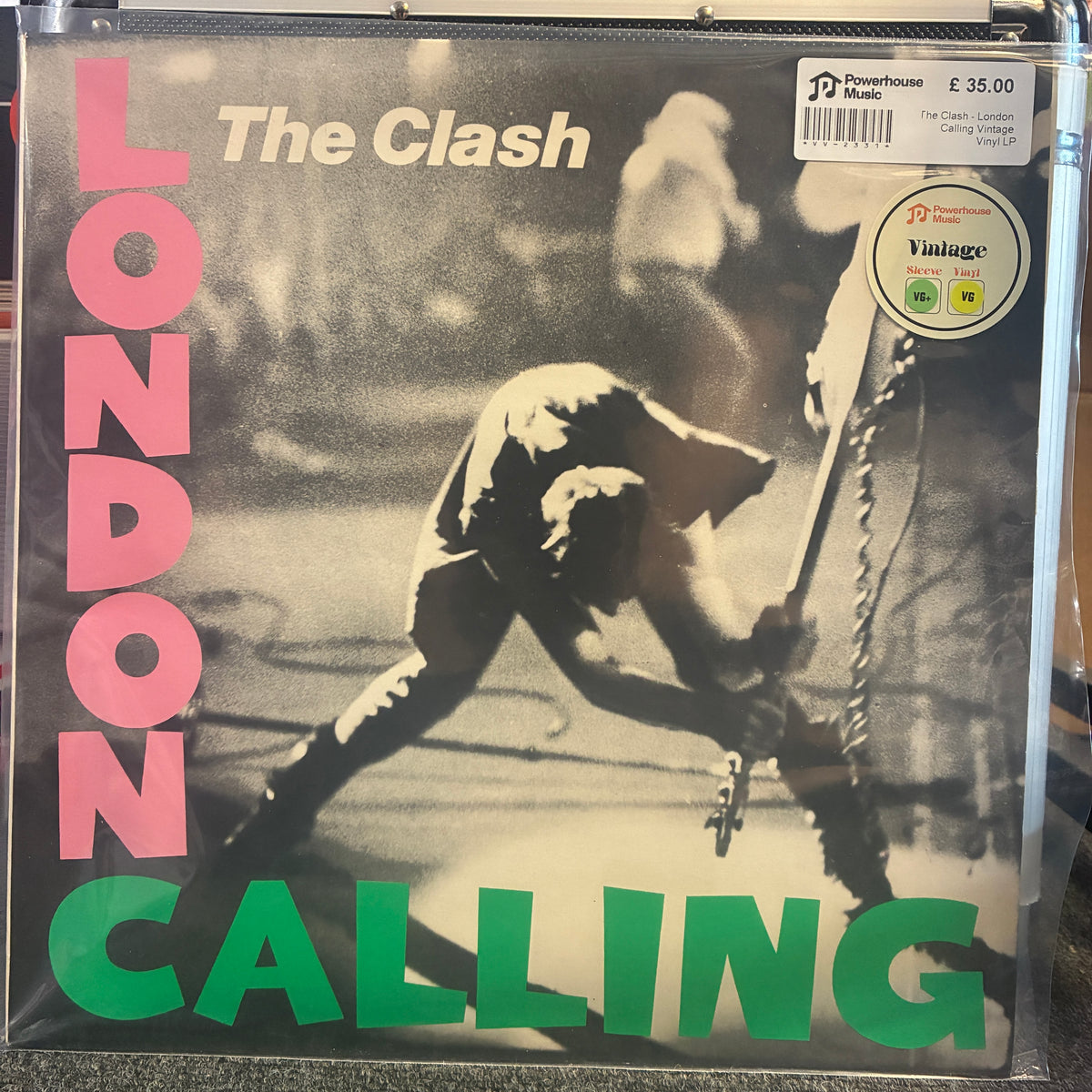 The Clash - London Calling Vintage Vinyl LP The Clash - London Calling vinyl record sleeve in a clear plastic protective case, with a Powerhouse Music sticker on the top right.