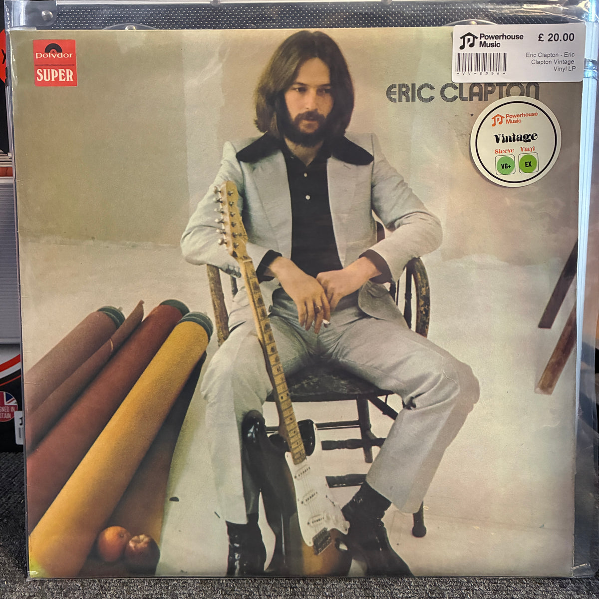 Eric Clapton - Eric Clapton Vintage Vinyl LP Eric Clapton 'Vantage' vinyl record album cover, released by EMI Records Super. The cover features a photo of Eric Clapton sitting on a chair holding an electric guitar, wearing a light gray suit and black shirt.