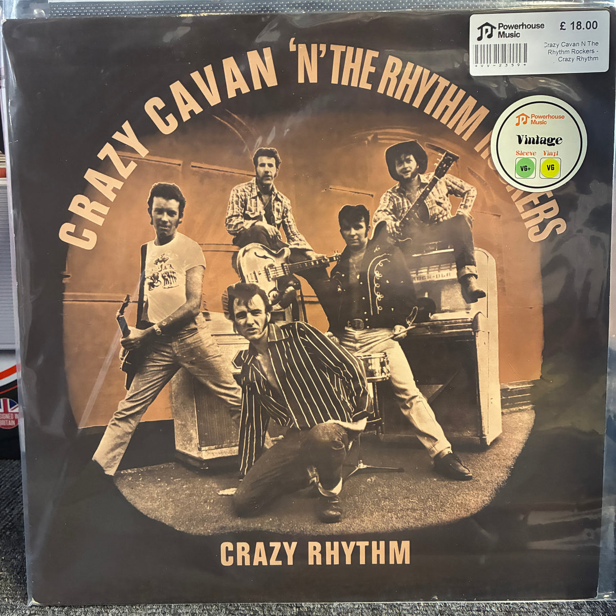 Crazy Cavan 'N' The Rhythm Rockers - Crazy Rhythm Vintage Vinyl LP A vinyl record sleeve for Crazy Cavan 'N' The Rhythm Players' album 'Crazy Rhythm' photographed flat against a dark textured surface. The cover art is sepia-toned with a group photo of five musicians and visible Pinnacle Music / Virgin Records branding, plus a barcode sticker and a round 'Vintage' label.