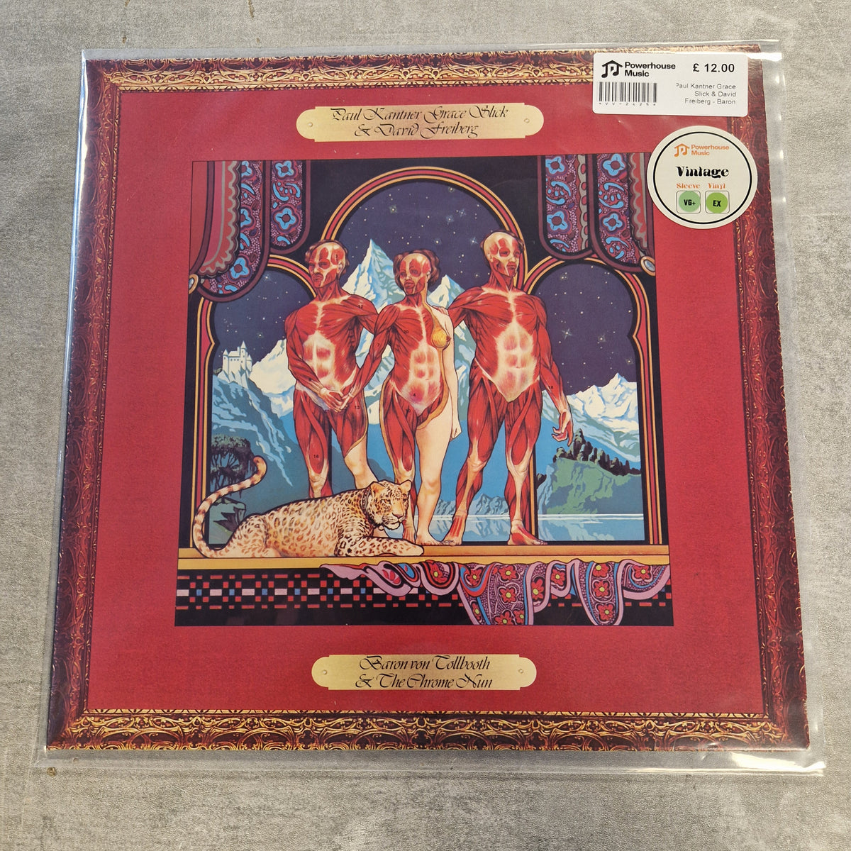 Paul Kantner, Grace Slick & David Freiberg - Baron Von Tollbooth & The Chrome Nun Vintage Vinyl LP A vinyl record sleeve for the band Scorn's 'Collective & The Throne Alone' album, sealed in plastic with a visible barcode sticker and a 'Vintage' label. The cover art features three anatomical-style muscular figures in a stylized room with mountains and a leopard, framed by a red border.