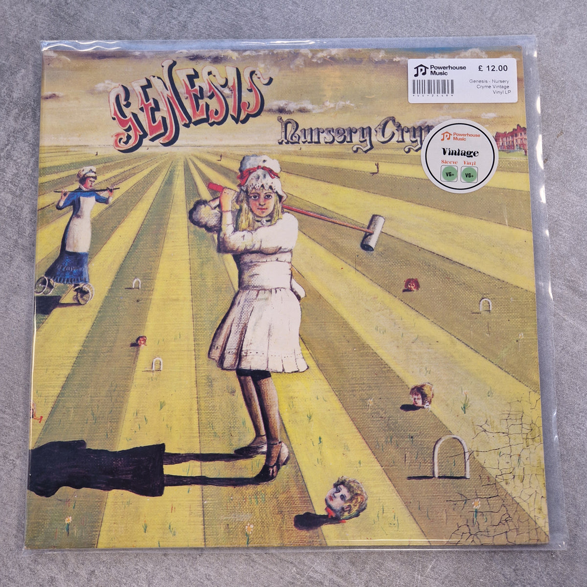 Genesis - Nursery Cryme Vintage Vinyl LP Genesis 'Nursery Cry' vinyl record album cover, sealed in a clear plastic sleeve, photographed on a gray textured surface. The cover art features a surreal yellow-and-beige field with a child in a white dress holding a mace, and the Genesis logo at the top.