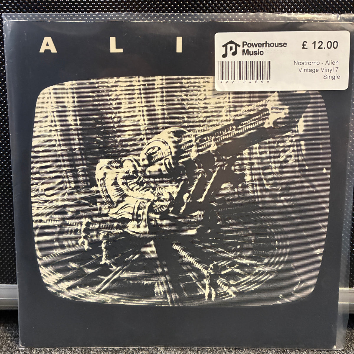 Nostromo - Alien Vintage Vinyl 7" Single Ali - Nostromo - Alien Vintage Vinyl LP Single jacket cover, featuring a black and white sci-fi illustration of a character in a spacesuit operating a large machine. A white Powerhouse Music label is visible in the top right corner.
