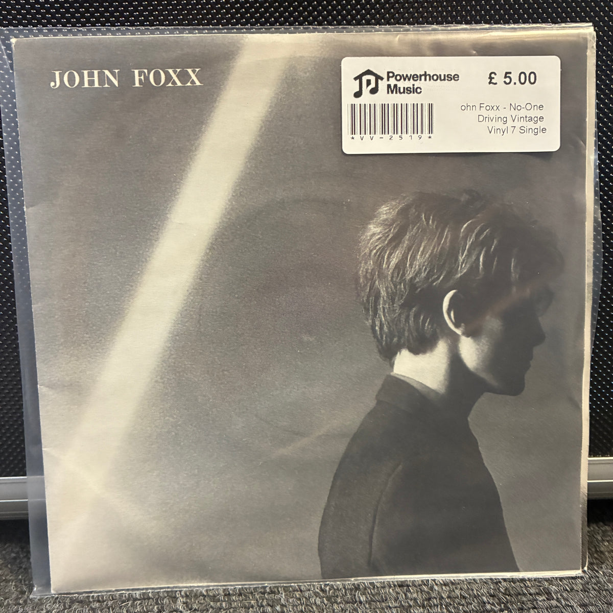 John Foxx - No-One Driving Vintage Vinyl 7" Single John Foxx 'Driving Vintage' vinyl single album cover in a clear plastic sleeve, with a Powerhouse Music sticker showing £5.00.