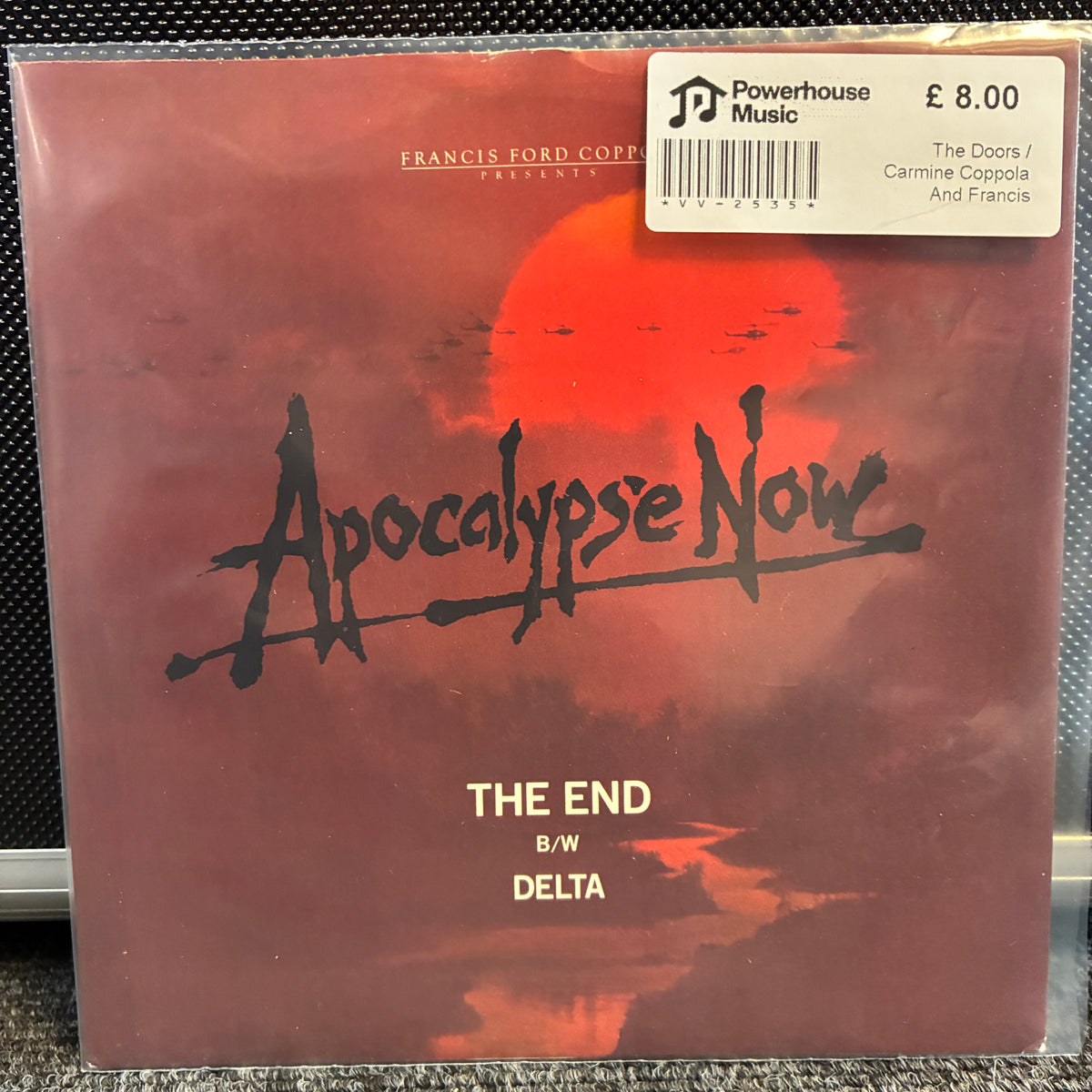 The Doors / Carmine Coppola And Francis Coppola - The End / Delta Vintage Vinyl 7" Single Vinyl record sleeve for 'The End B/W' by Delta, featuring a red and orange sunset design with the title 'Apocalypse Now' in black script. A Powerhouse Music price sticker is visible in the top right corner.