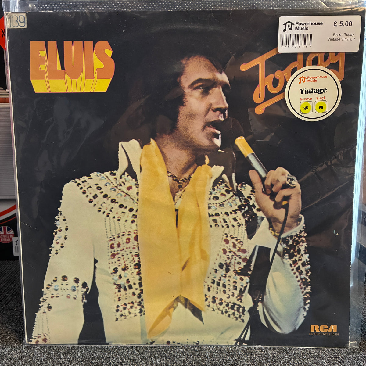 Elvis - Today Vintage Vinyl LP A vintage Elvis Presley 'Today' vinyl record LP in its shrink wrap, featuring the album cover art with Elvis in a white embellished jacket and yellow scarf. The record label shows 'RCA' in the bottom right corner, and a 'Powerhouse Music' sticker is visible in the top right.
