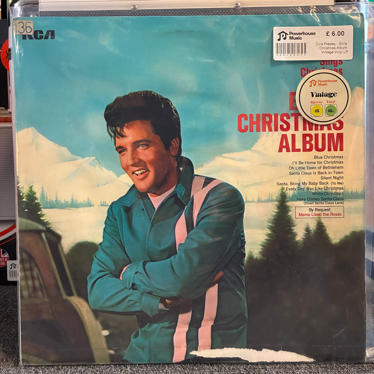 Elvis Presley - Elvis' Christmas Album Vintage Vinyl LP Elvis Presley's 'Christmas Album' vinyl record cover, showing Elvis in a teal jacket against a snowy mountain background. The record is sealed in a clear plastic sleeve with visible Powerhouse Music and Virgin labels.