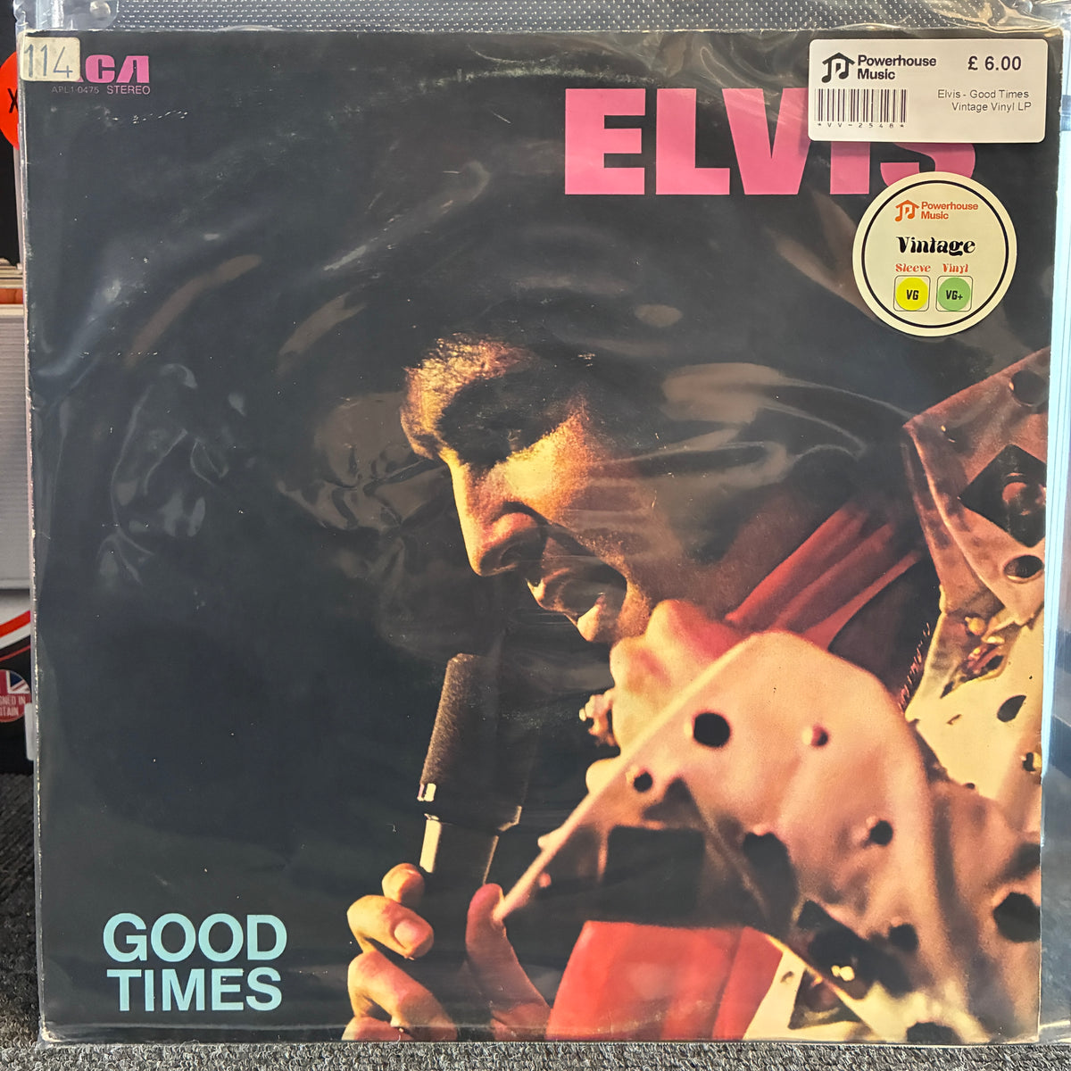 Elvis - Good Times Vintage Vinyl LP Elvis 'Good Times' vinyl record sleeve in shrink wrap, showing a close-up portrait of Elvis with a microphone and pink title text. A Powerhouse Records sticker and barcode are visible on the top right.
