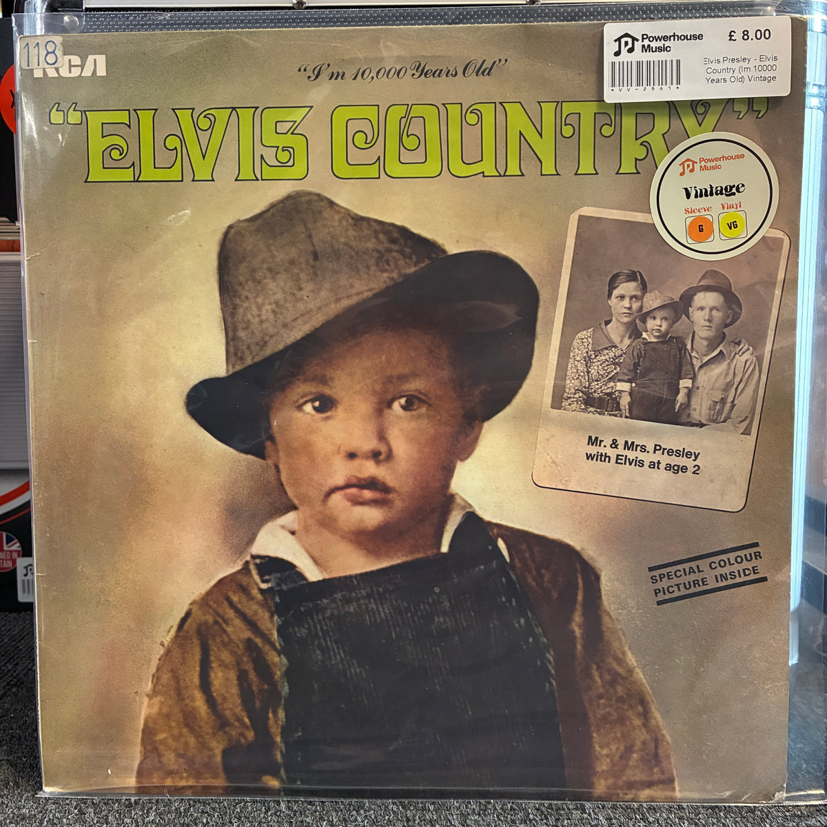 Elvis Presley - Elvis Country (I'm 10000 Years Old) Vintage Vinyl LP A vinyl record sleeve for Elvis Country, featuring a vintage-style portrait of a young boy in a hat and overalls. The cover has a warm beige background with green title text and a small inset photo.