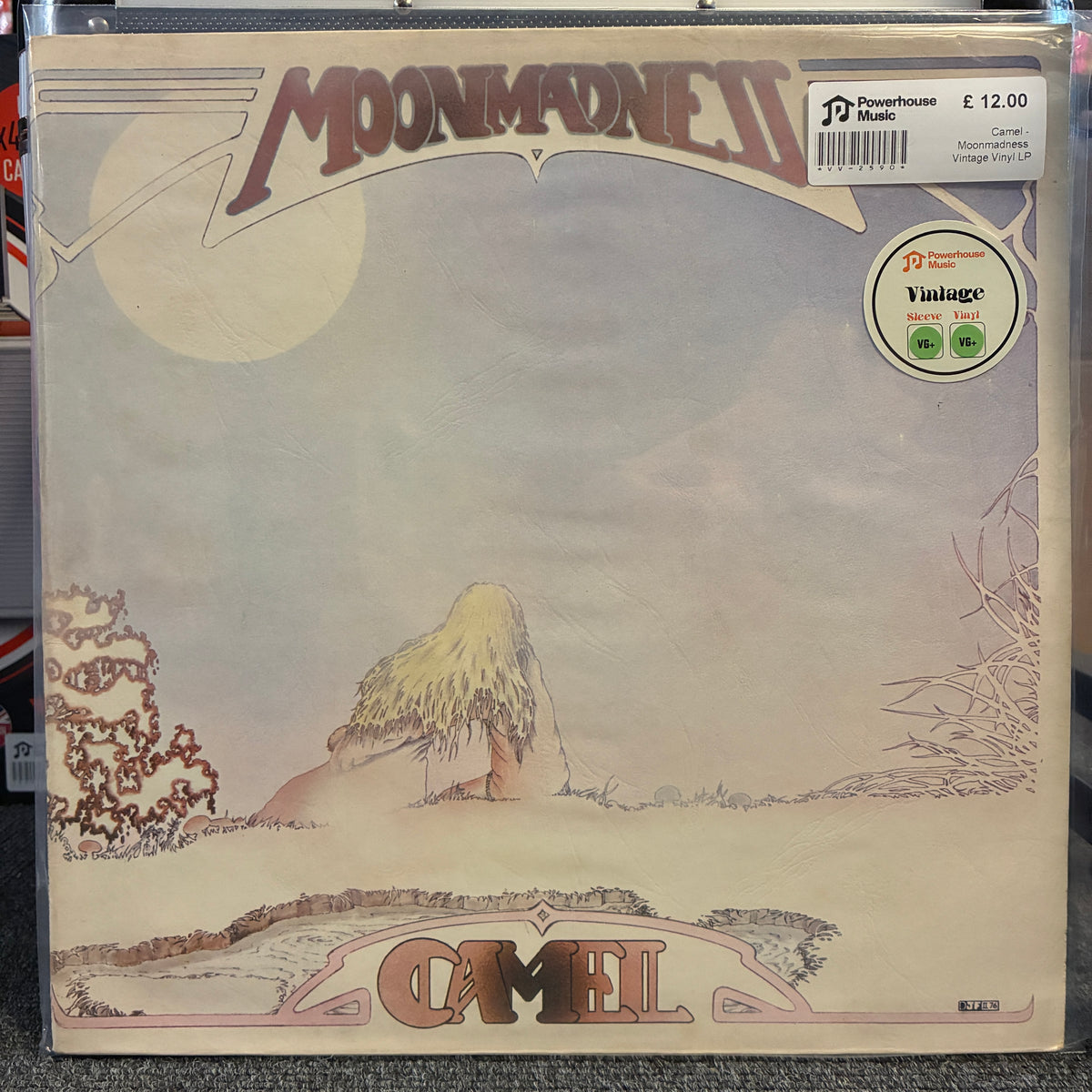 Camel - Moonmadness Vintage Vinyl LP Camel - Moonmadness II vinyl record sleeve, showing the illustrated cover art with a large moon, a seated figure, and a vintage-style desert landscape. A Powerhouse Music sticker and a Vintage sticker are visible on the top right.