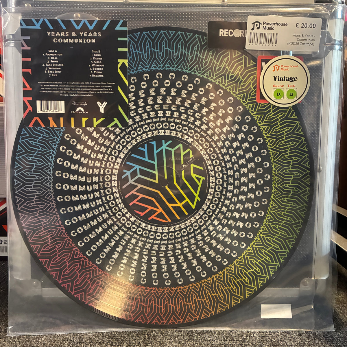 Years & Years - Communion (RSD25 Zoetrope) Vintage Vinyl LP A vinyl record package in a clear plastic sleeve, featuring a circular disc with concentric geometric patterns and the title 'Years & Years Communion' on the cover. Visible text includes '70 Years & Years Basic' and a 'Valuage' sticker.