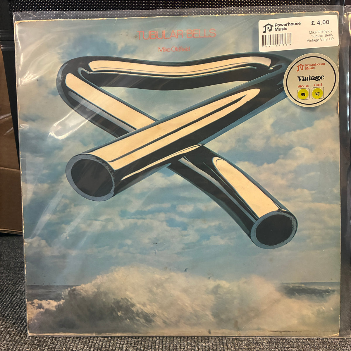 Mike Oldfield - Tubular Bells Vintage Vinyl LP A vinyl record sleeve for Tubular Hell's 'Metal Lament' on Powerhouse Records, sealed in a clear protective plastic sleeve. The cover art features a surreal illustration of two metallic pipes forming an 'X' shape against a cloudy sky and ocean waves.