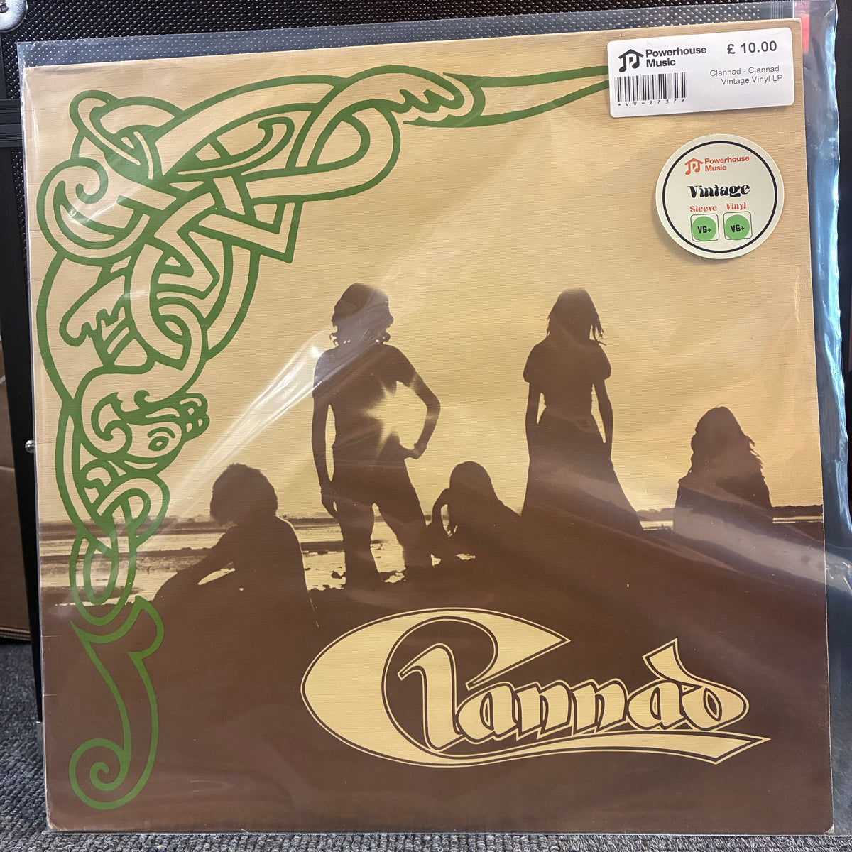 Clannad - Clannad Vintage Vinyl LP A vintage Canned Beats 'Cannad' 12-inch vinyl record sleeve in its clear plastic shrink-wrap, featuring a sepia-toned beach scene with silhouettes and green Celtic knotwork on the left side.