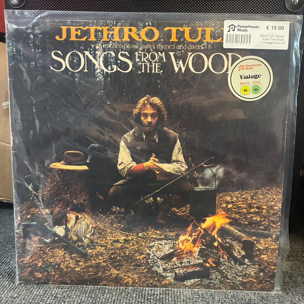 Jethro Tull - Songs From The Wood Vintage Vinyl LP Jethro Tull - Songs from the Wood vinyl record album cover, sealed in a clear plastic sleeve with a Powerhouse Music sticker and a Vintage record sticker on the top right.