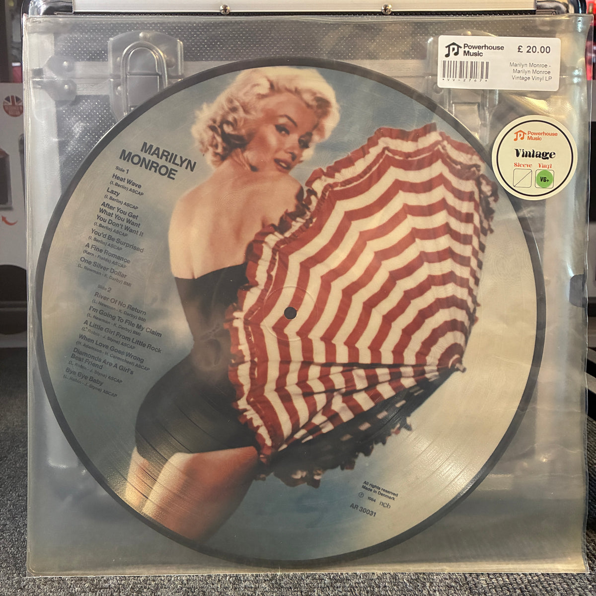 Marilyn Monroe - Marilyn Monroe (Picture Disc) Vintage Vinyl LP A vinyl record package featuring a circular Marilyn Monroe picture disc with the album cover art, sealed in a clear plastic sleeve. Visible text includes 'Marilyn Monroe', track listings, and a sticker reading 'Picture Version Vintage'.