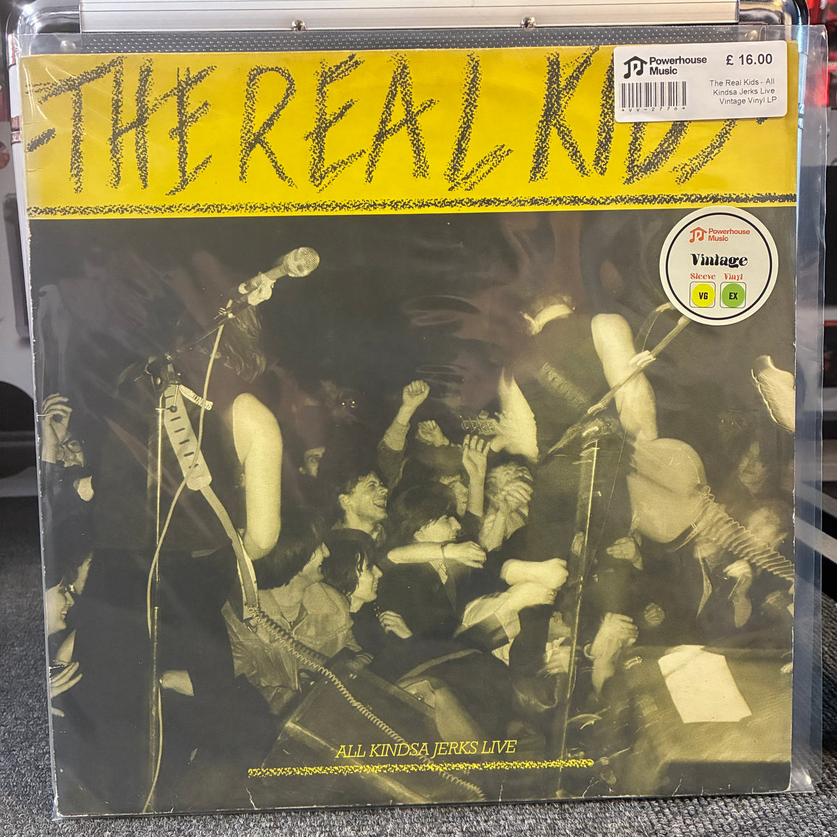 The Real Kids - All Kindsa Jerks Live Vintage Vinyl LP The Real Kids 'All Kinda Jerks Live' vinyl record in its original shrink wrap, featuring a yellow header with the band's name and a black-and-white concert photograph.