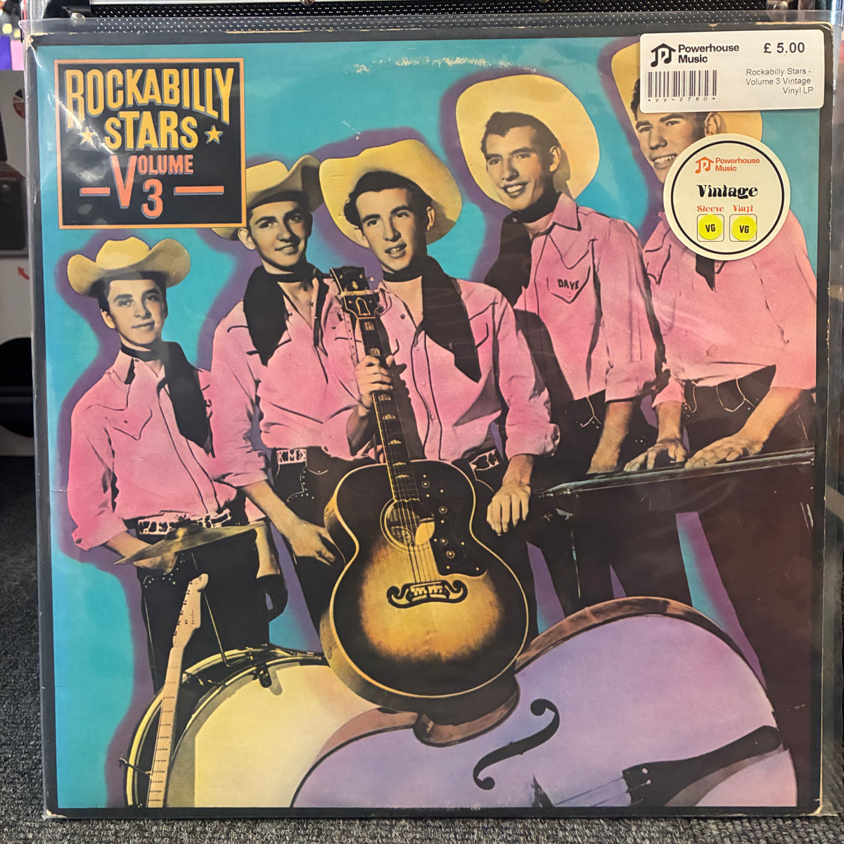 Rockabilly Stars - Volume 3 Vintage Vinyl LP Rockabilly Stars Volume 3 vinyl record cover, featuring illustrated cowboy musicians in pink shirts and yellow hats against a turquoise background, with a Powerhouse Music sticker in the top right corner.