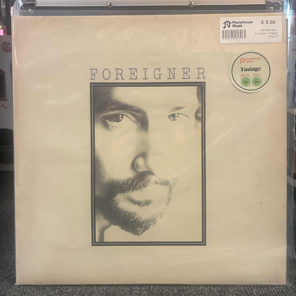 Cat Stevens - Foreigner Vintage Vinyl LP Foreigner vinyl record album cover in its clear plastic shrink wrap, showing the beige cover with the band's name and a black-and-white portrait. A Vintage and Discstore sticker is visible in the top right corner.