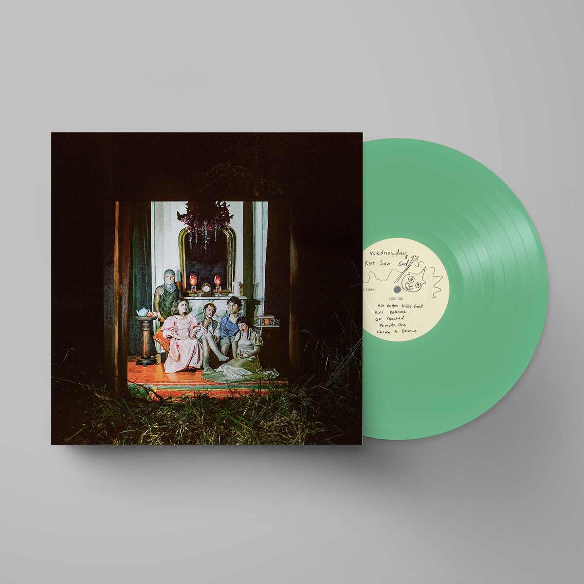 Wednesday - Rat Saw God (Seafoam Green) Vinyl A vinyl record partially pulled from its sleeve, showing a mint green record with a cream label next to a dark square album cover featuring an art print of a historical family scene.