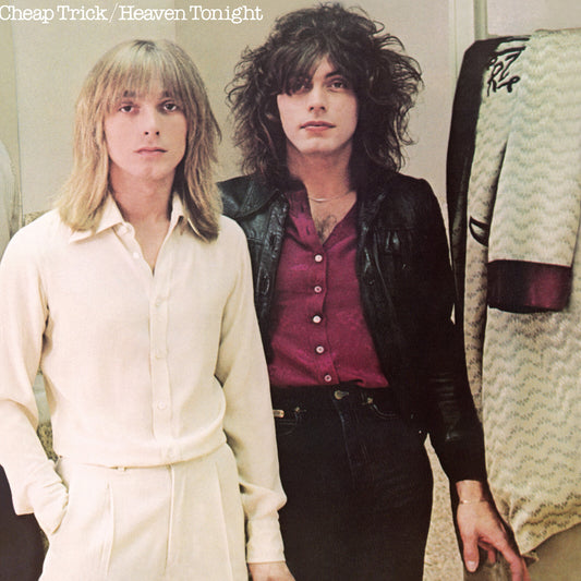 Cheap Trick - Heaven Tonight (Translucent Violet) Vinyl Two men standing indoors, one with long blonde hair wearing a cream button-up shirt and matching pants, and the other with dark curly hair wearing a black leather jacket over a burgundy button-up shirt and dark pants. A patterned garment hangs on a rack to the right, and the text 'Cheap Trick / Heaven Tonight' appears at the top.