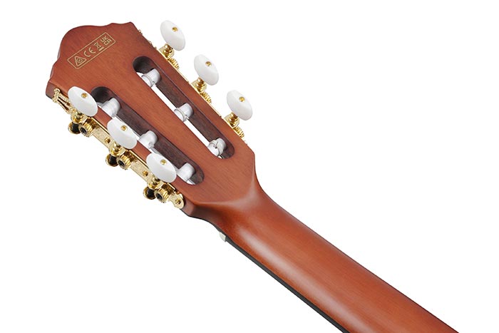 Close-up of a guitar headstock with tuning pegs on a white background
