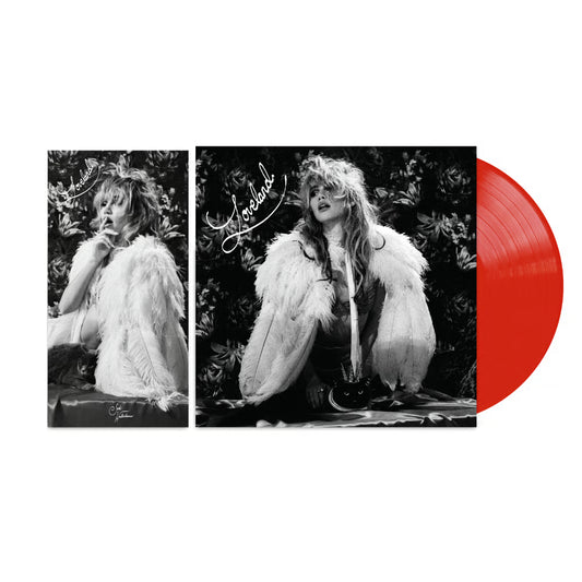Suki Waterhouse - Loveland  A vinyl record album shown on a white background, featuring a black-and-white cover with a seated woman in a white feathered coat and a bright red translucent record partially visible behind the cover.